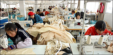 Chinese workers sew at a garment factory in Jiaxin, Zhejiang Province, western China