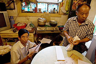 Aggrieved citizens from China's provinces live in a crowded Beijing village while petitioning the government, which plans to raze the village ahead of the Olympics.