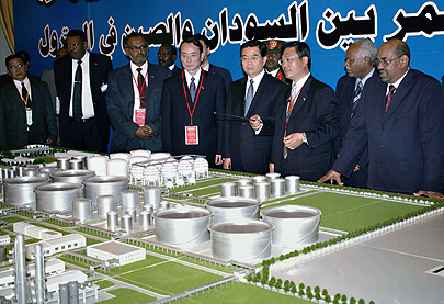 Sudanese President Omar al-Bashir, right and his Chinese counterpart Hu Jintao, third right, look at a model of an oil refinery during a visit to the facility north of Khartoum in February. China and other Asian countries have invested billions in Africa - but much of it in the continent's resource industries. 
