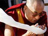 The Dalai Lama of Tibet offers a white scarf, called a kata, as he is greeted by Senator Con di Nino, co-chairman of the Parliamentary Friends of Tibet, as he arrives at the Ottawa International Airport.