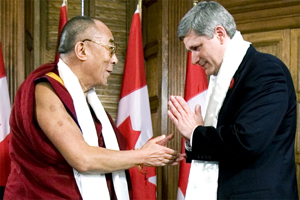 Canadian Prime Minister Stephen Harper thanks the Dalai Lama after exchanging Katas prior to their meeting on Parliament Hill, in Ottawa Monday Oct. 29, 2007