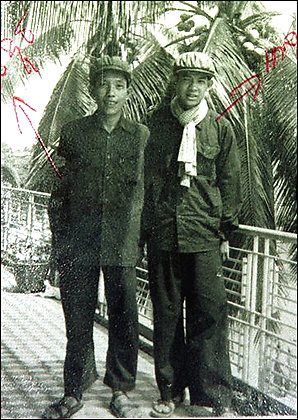 In this photo from the Cambodian Documentation Center shows Kaing Khek Iev, left, also know as Duch, and his aid Sok in Phnom Penh in 1976.  Duch, who ordered the torture and killing of at least 14,000 men, women and children, in the late 1970's has been take to the Cambodian genocide tribunal headquarters Tuesday, July 31, 2007, to be questioned by judges.  On July 18, 2007, prosecutors submitted to the investigating judges the cases of five former Khmer Rouge leaders recommended to stand trial.  The names of the five suspects have not been revealed.  (AP Photo/Documentation Center, File)