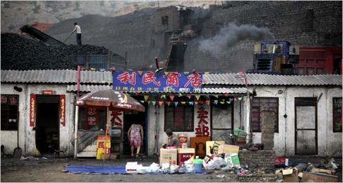 China’s industrial growth depends on coal, plentiful but polluting, from mines like this one in Shenmu, Shaanxi Province, behind a village store.