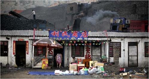 China&rsquo;s industrial growth depends on coal, plentiful but polluting, from mines like this one in Shenmu, Shaanxi Province, behind a village store.