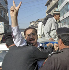 Police officers arrest a lawyer who was protesting Monday in Peshawar, Pakistan, against President Gen. Pervez Musharraf's declaration of a state of emergency.