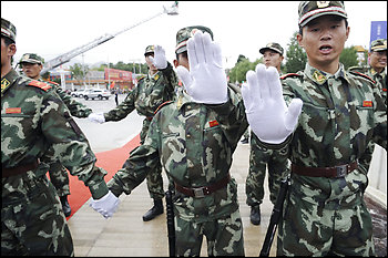 Chinese Armed Police officers try to block a photographer from taking pictures of them on a street in Lhasa, capital of southwest China's Tibet Autonomous Region on Saturday, June 21, 2008, as the Olympic torch is to make its way through Tibet's sealed-off capital.